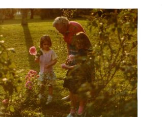 my sister and I cutting roses with Mama Ruthie (my great grandmother)